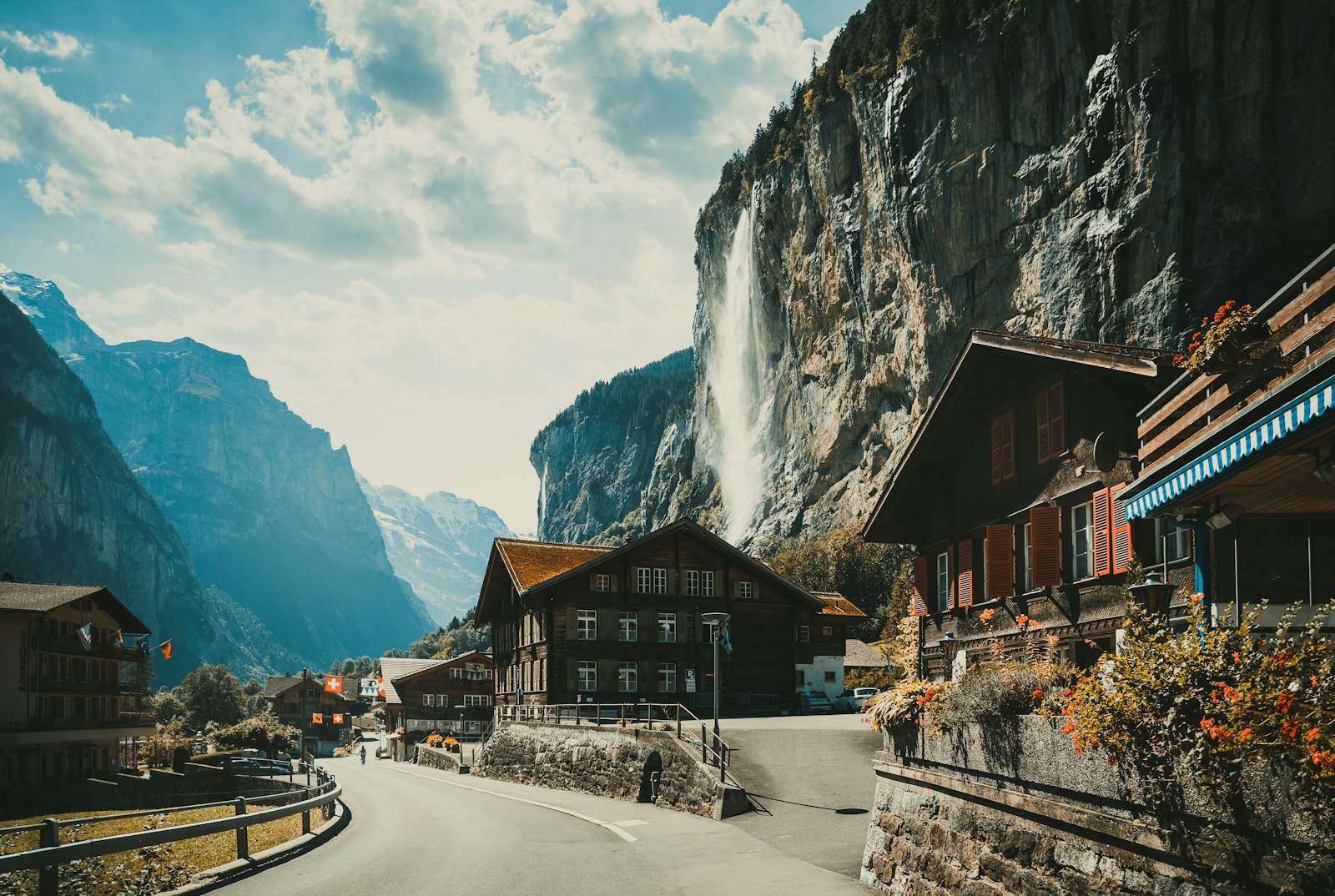 Swiss village in Lauterbrunnen with alpine cliffs and waterfall