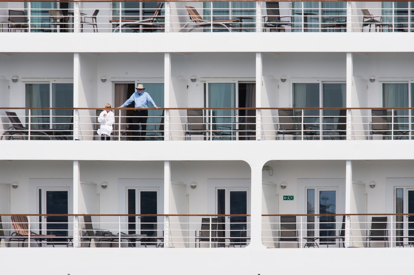 Travelers enjoying the private outdoor space of a cruise ship veranda