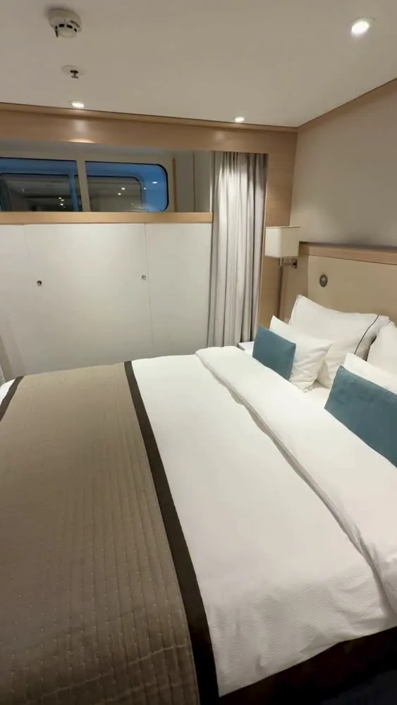 Viking Rinda cabin with a high horizontal window beside the bed